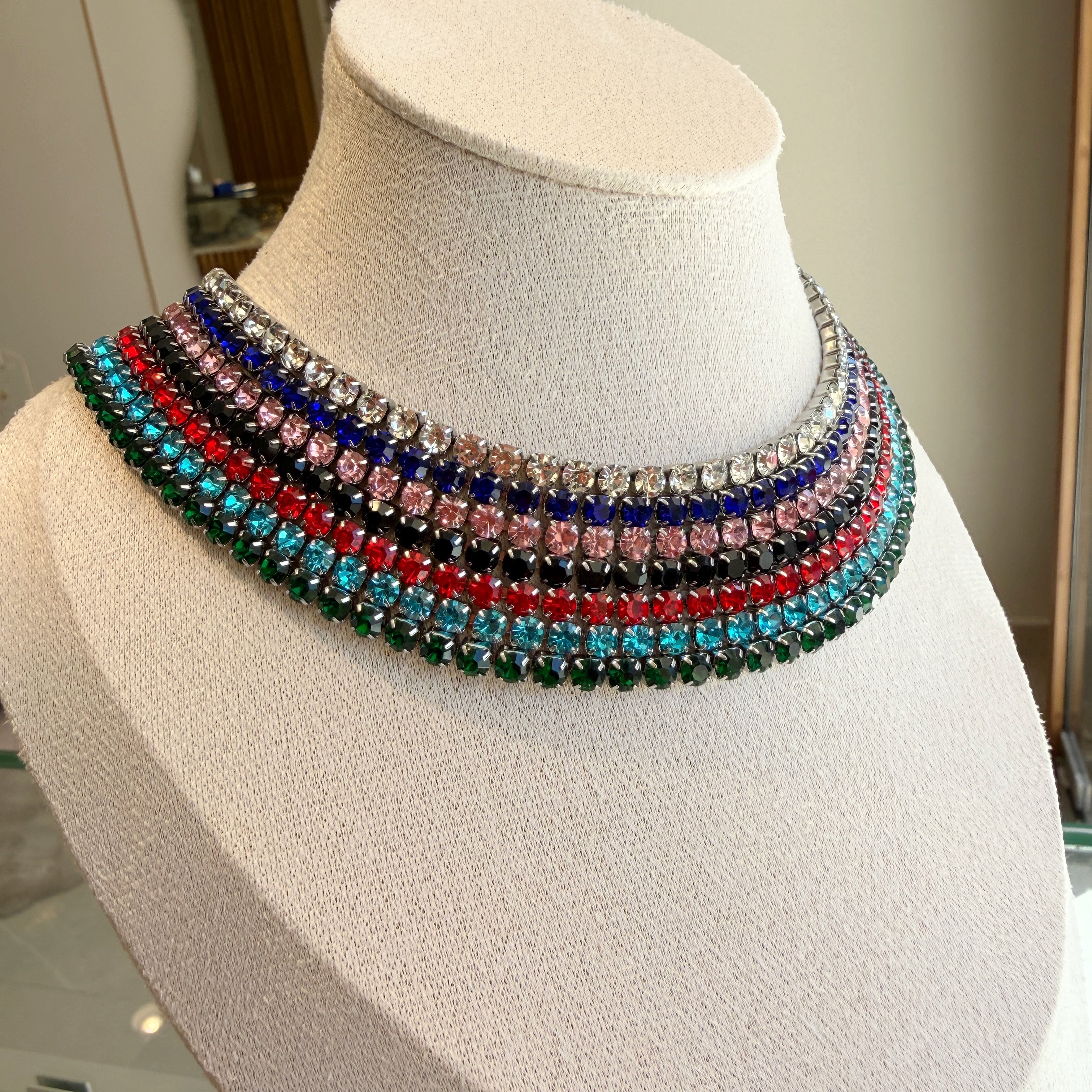 Multicolored beaded necklace on a mannequin bust tennis necklace