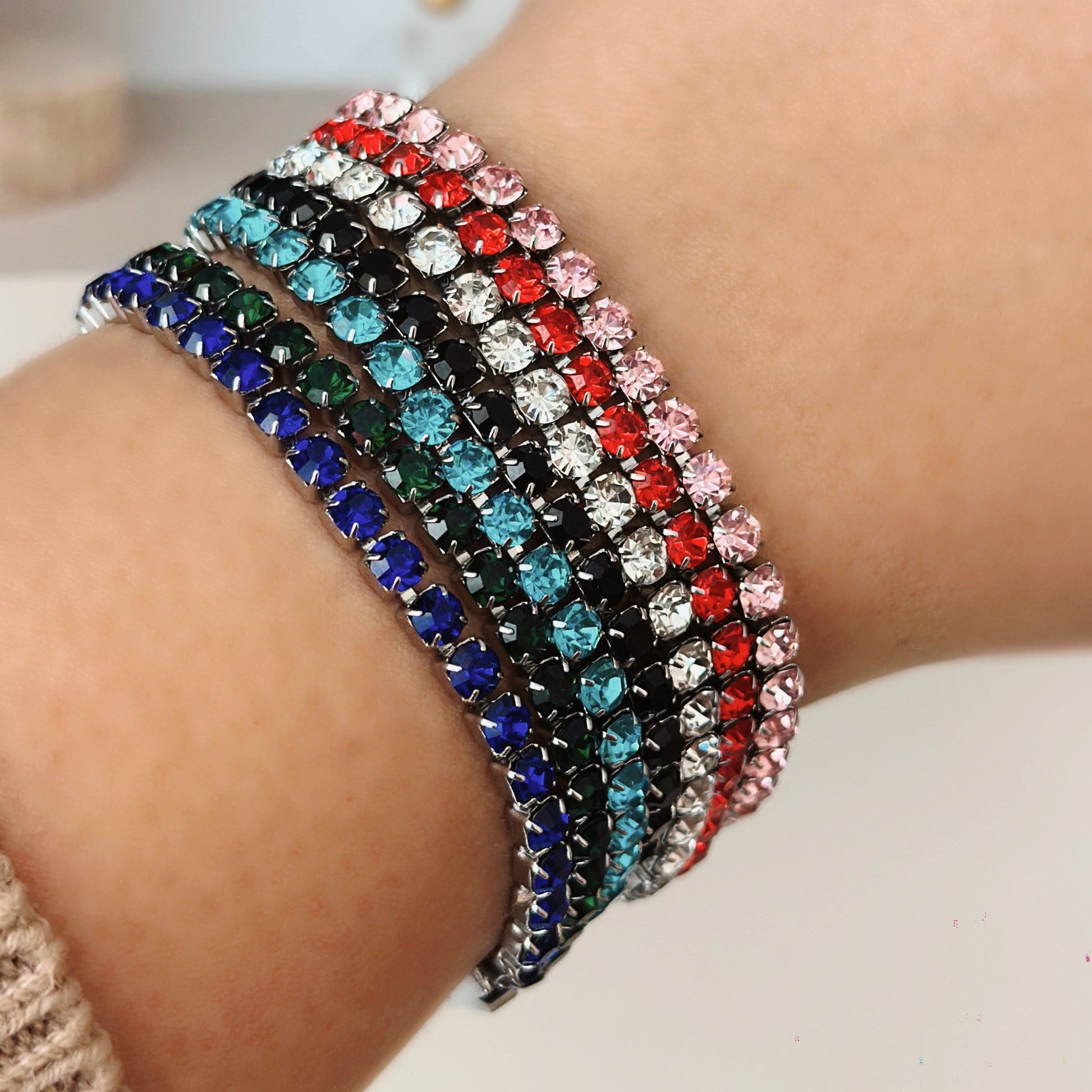 Multicolored beaded bracelet on a wrist with a blurred background